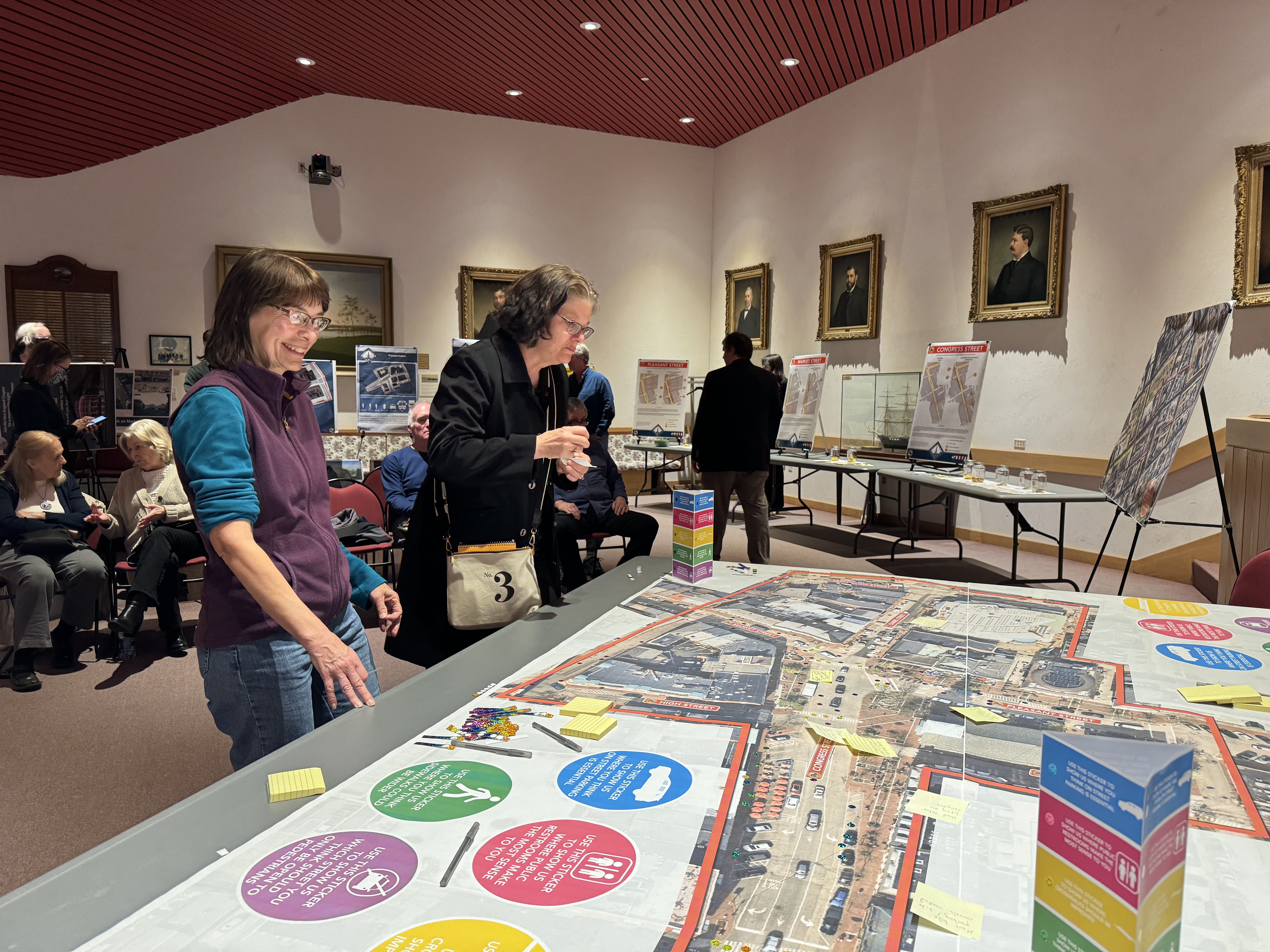 Residents pore over a map of Market Square in Council Chambers during the Market Square Master Plan Public Meeting