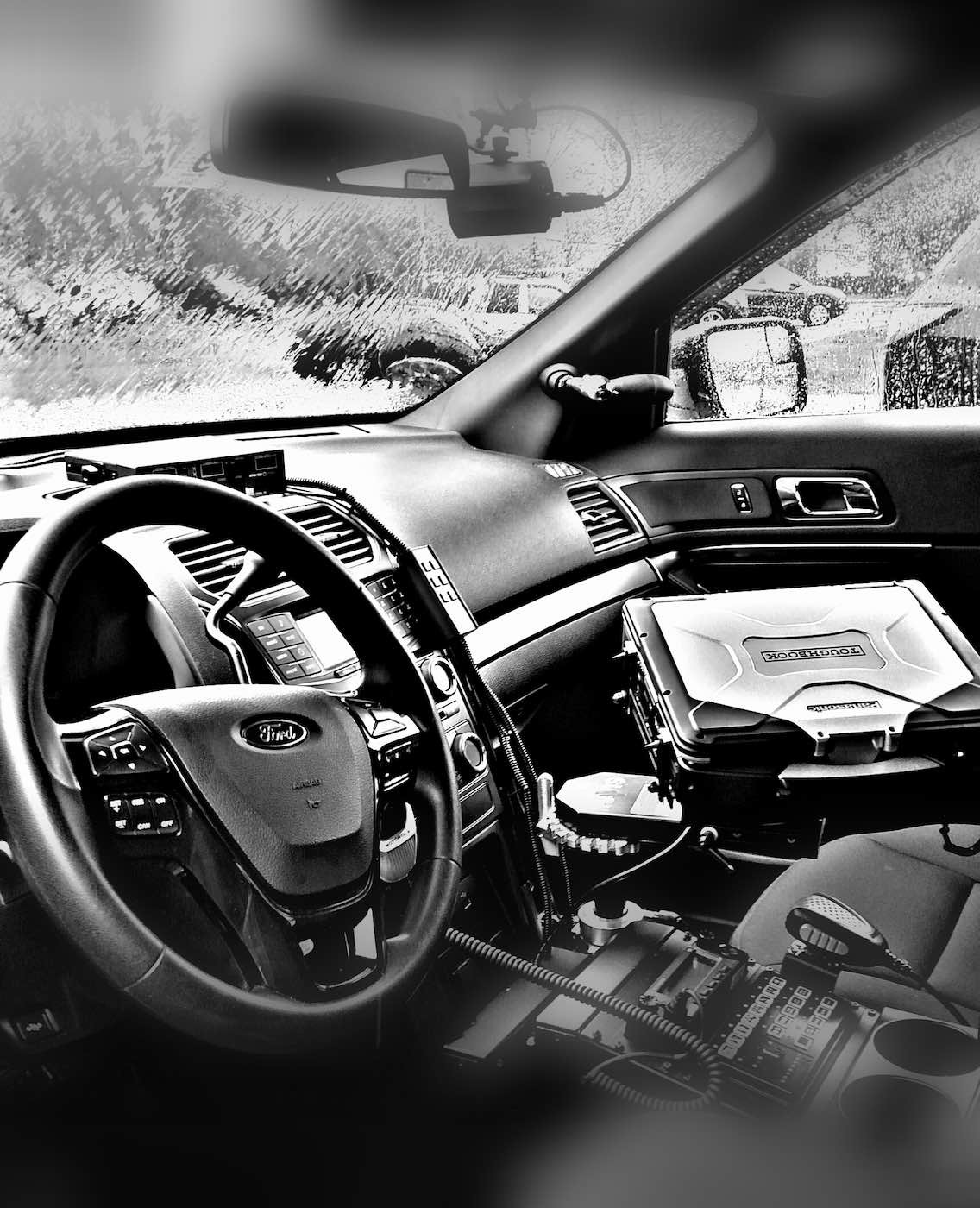 Black and white photo of the interior dashboard of a Police vehicle