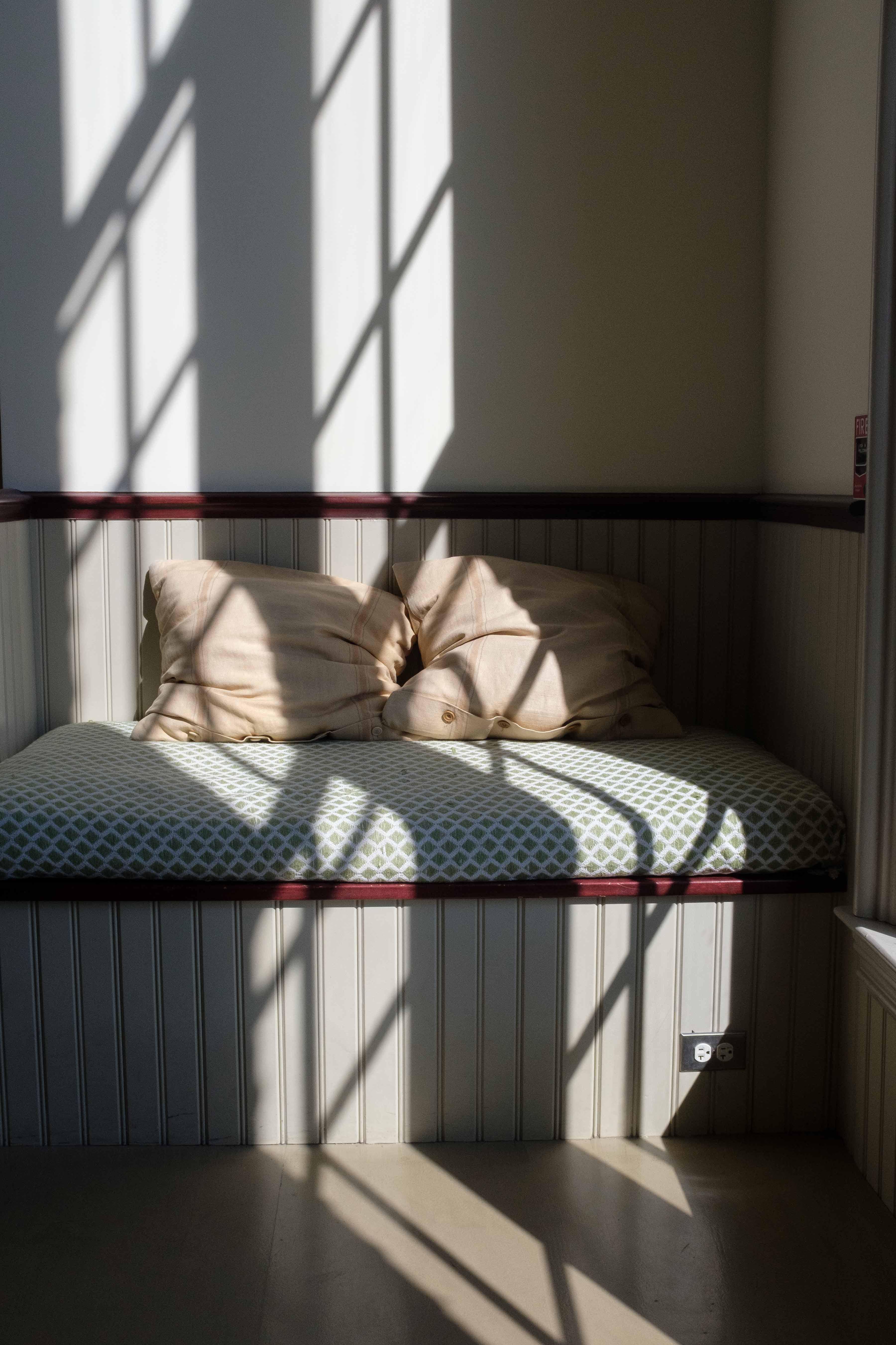 Light and shadow from a window on a built-in window seat