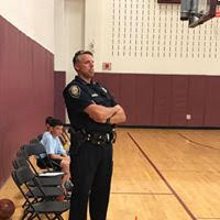 Police Officer watching basketball game