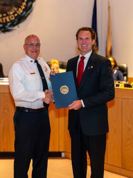 Mayor McEachern presenting proclamation to Fire Chief Bill McQuillen