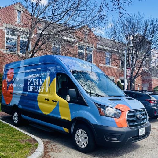 the library's all electric bookmobile van sits in front of the library building. It is decorated with colorful shapes on a vibrant blue background.