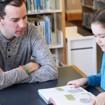 Child reading to an Adult