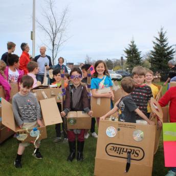 Crowd of children in homemade spaceships getting ready to race