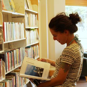 Woman browses new books shelf