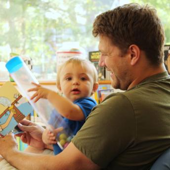 Father and baby read together