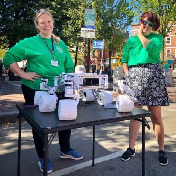 Two library staff members standing outside