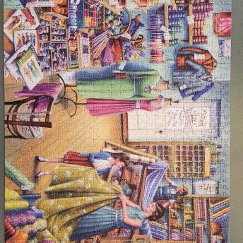Woman behind register, Mom and daughter looking at fabrics. 