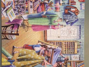 Woman behind register, Mom and daughter looking at fabrics. 