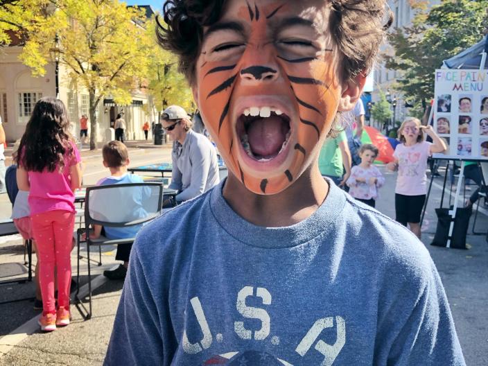 Boy in Market Square with tiger facepaint