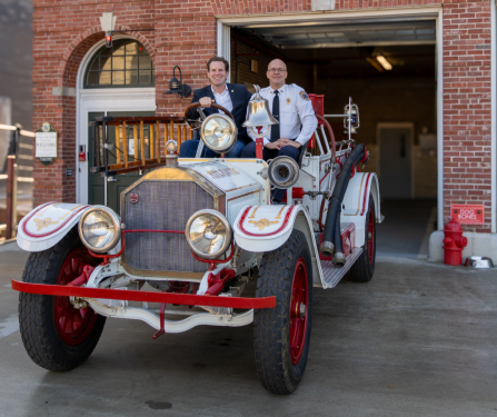 Portsmouth NH Mayor Deaglan McEachern and Fire Chief William McQuillen in the 1920s antique fire truck gifted to the City by Bayberry Vintage Auto.