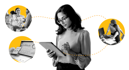 Woman standing reading a report with computer in the background