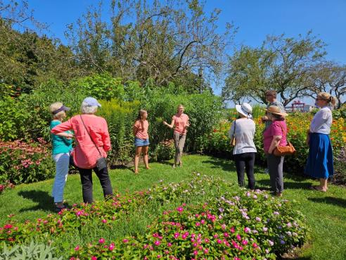 Parks & Greenery Department interns lead a garden tour in Prescott Park in 2024.