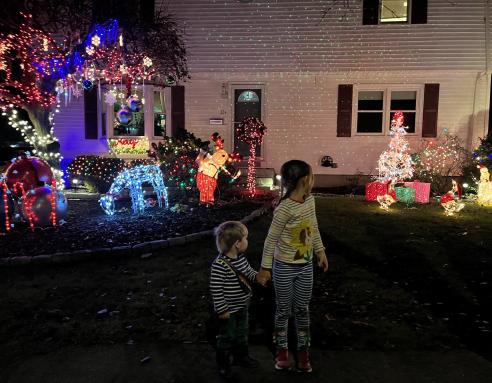 Admiring neighborhood holiday lights contest decorations.