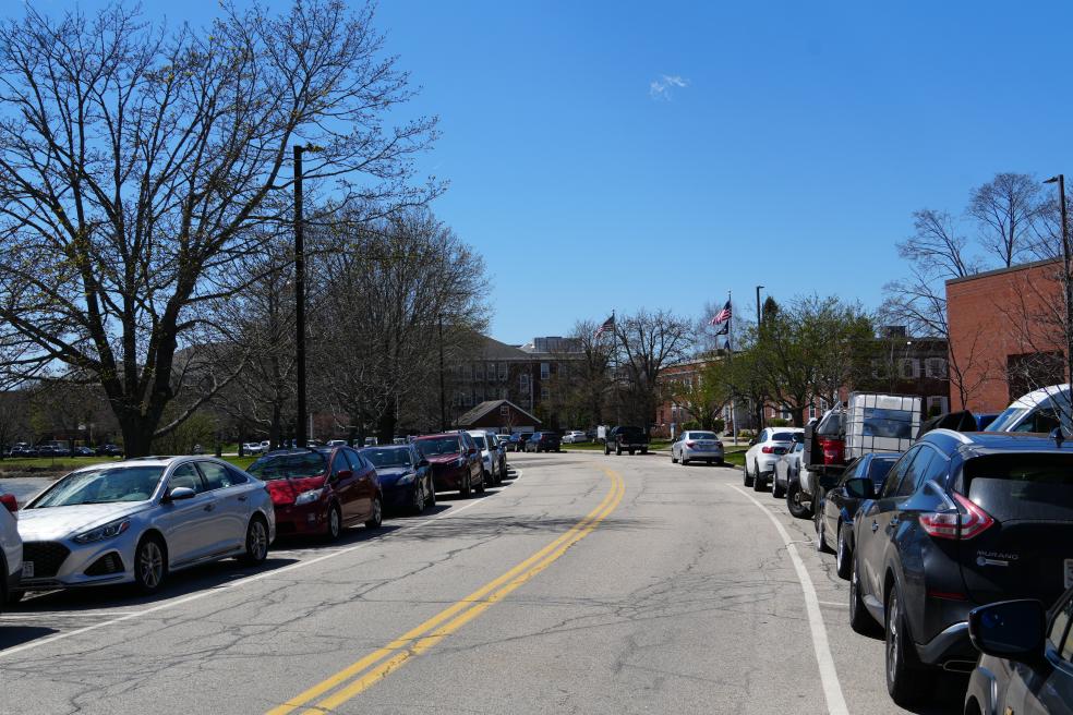 photo of cars parked along a street on a clear spring day