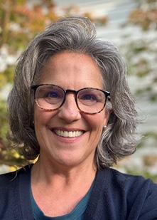 Headshot of Councilor Flynn with a blurred background of trees