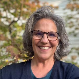 Headshot of Councilor Flynn with a blurred background of trees