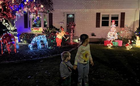 Admiring neighborhood holiday lights contest decorations.